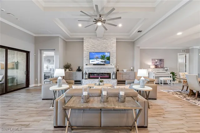 a living room with furniture a large window and a chandelier
