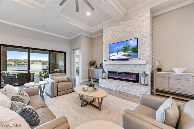 a living room with furniture a fireplace and a large window