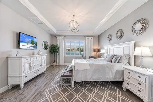 a bedroom with a bed and a chandelier