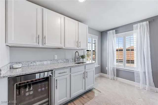 a living room with furniture floor to ceiling window next to a yard