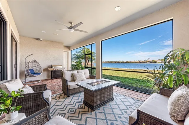 a living room with patio furniture and a potted plant
