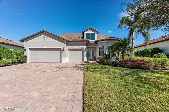 a front view of a house with a yard and garage