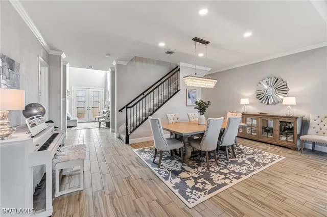 a view of a dining room with furniture a rug and wooden floor