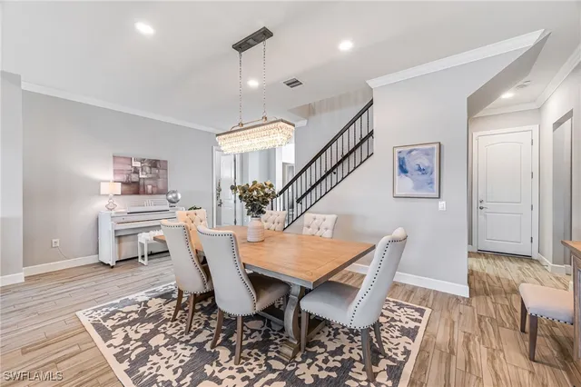 a dining room with furniture and wooden floor