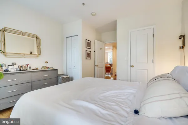 a bedroom with a bed and a dresser