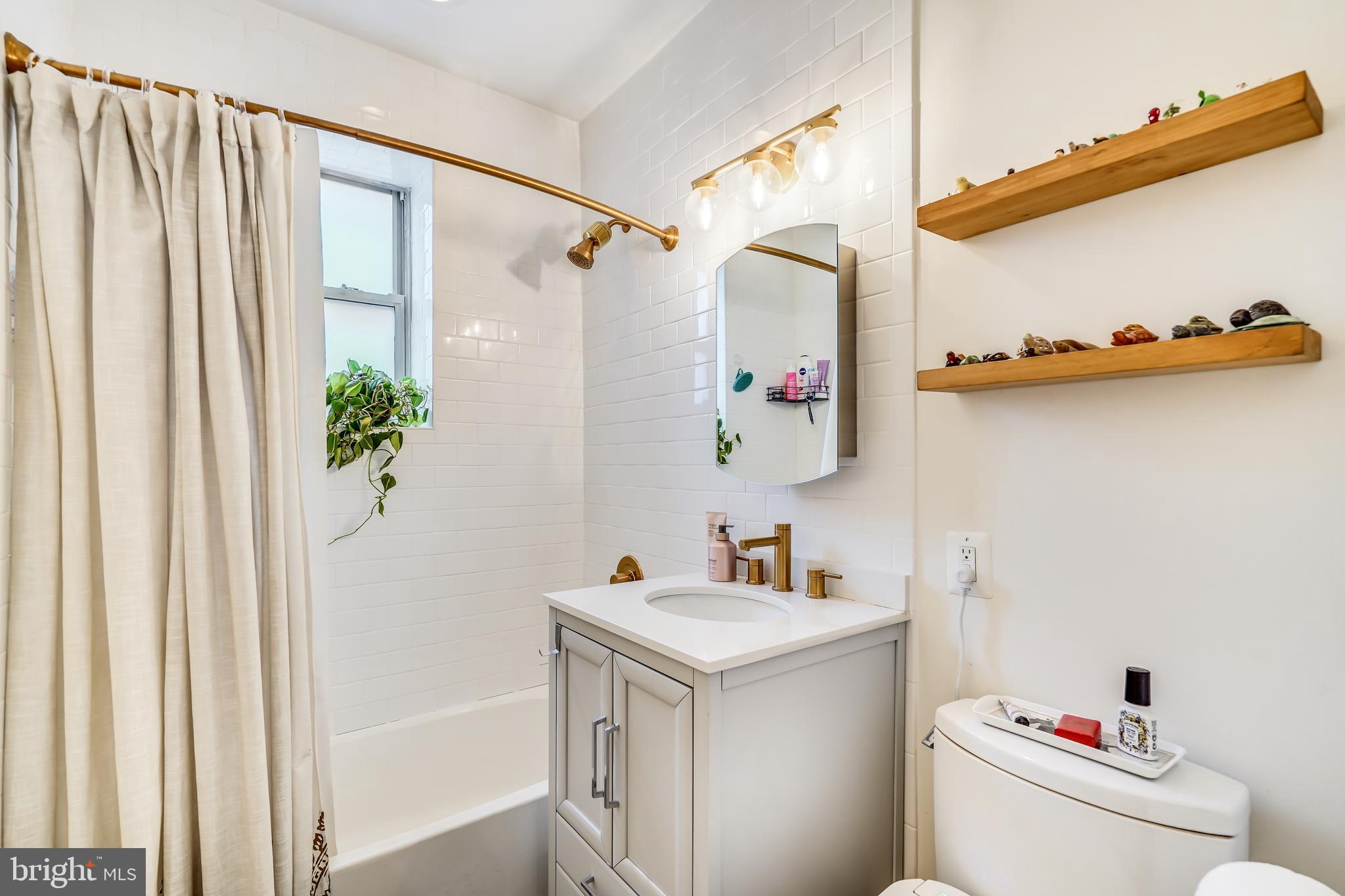 5405 9th Street Northwest, Unit 106 Washington, DC 20011 - Photo 18 of 21 a bathroom with a sink and a mirror