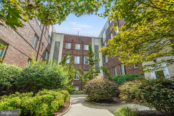 a front view of a residential houses with yard and green space