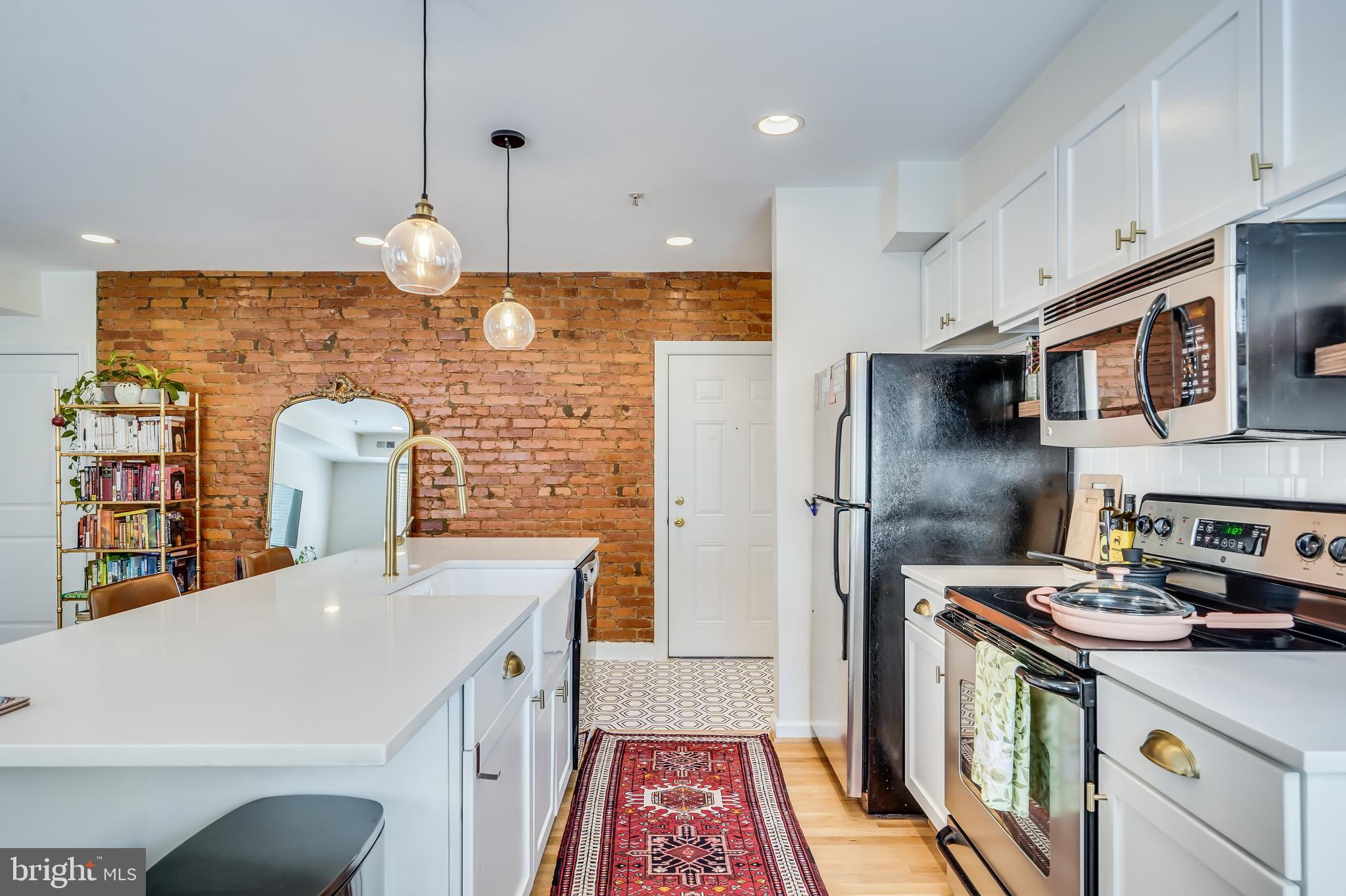 5405 9th Street Northwest, Unit 106 Washington, DC 20011 - Photo 8 of 21 a kitchen with stainless steel appliances granite countertop a sink a stove a refrigerator and cabinets