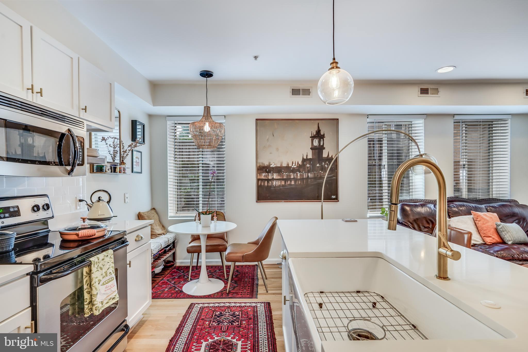 5405 9th Street Northwest, Unit 106 Washington, DC 20011 - Photo 9 of 21 a living room with furniture a flat screen tv and kitchen view