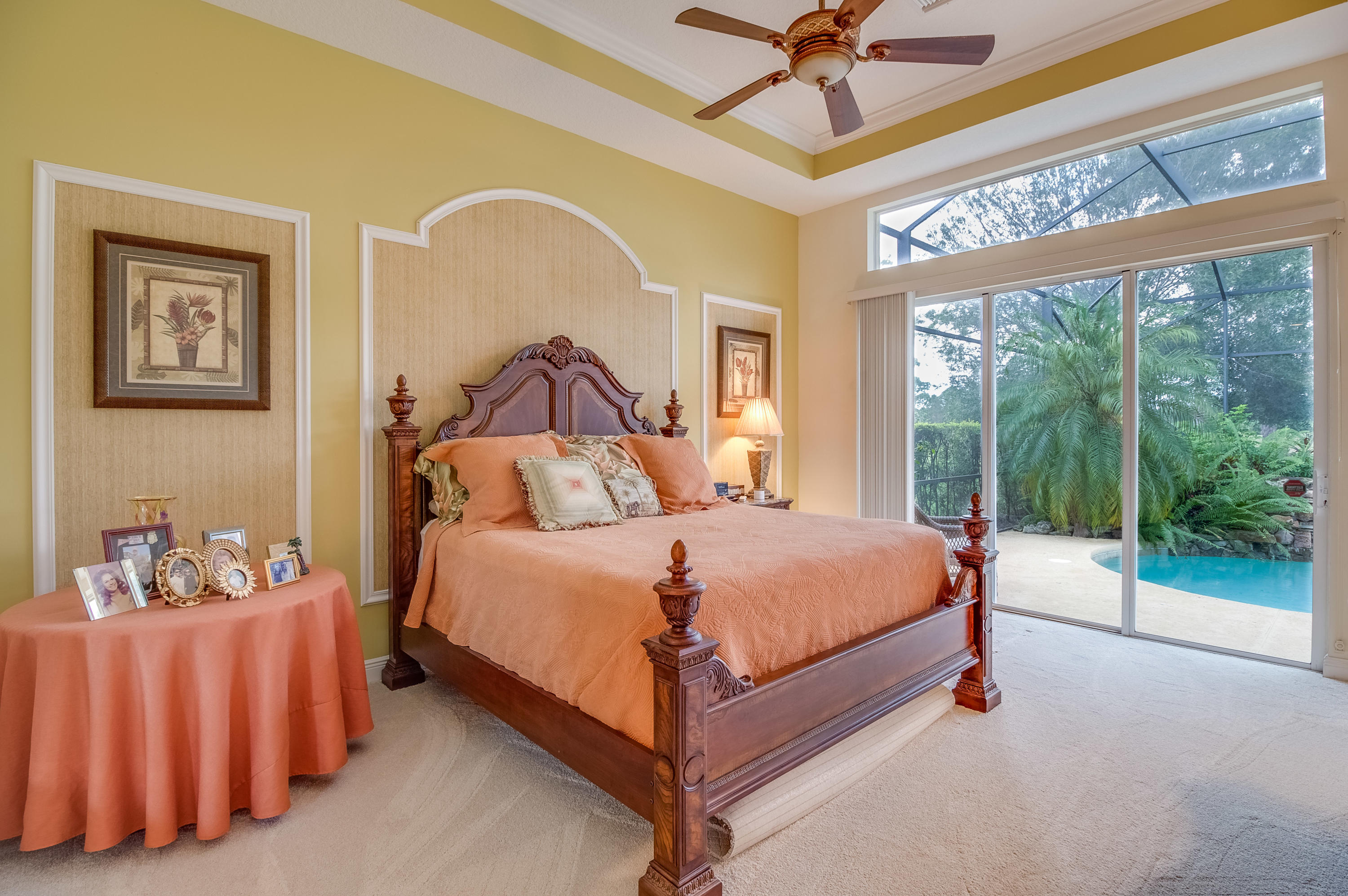 8617 Tompson Point Road Port St. Lucie, FL 34986 - Photo 23 of 38 a bed room with a bed and a chandelier