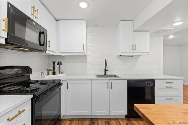 a view of kitchen with sink and wooden floor