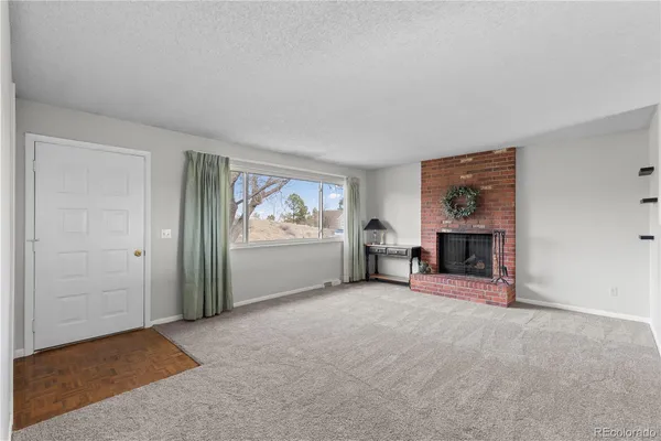 an empty room with furniture and a fireplace