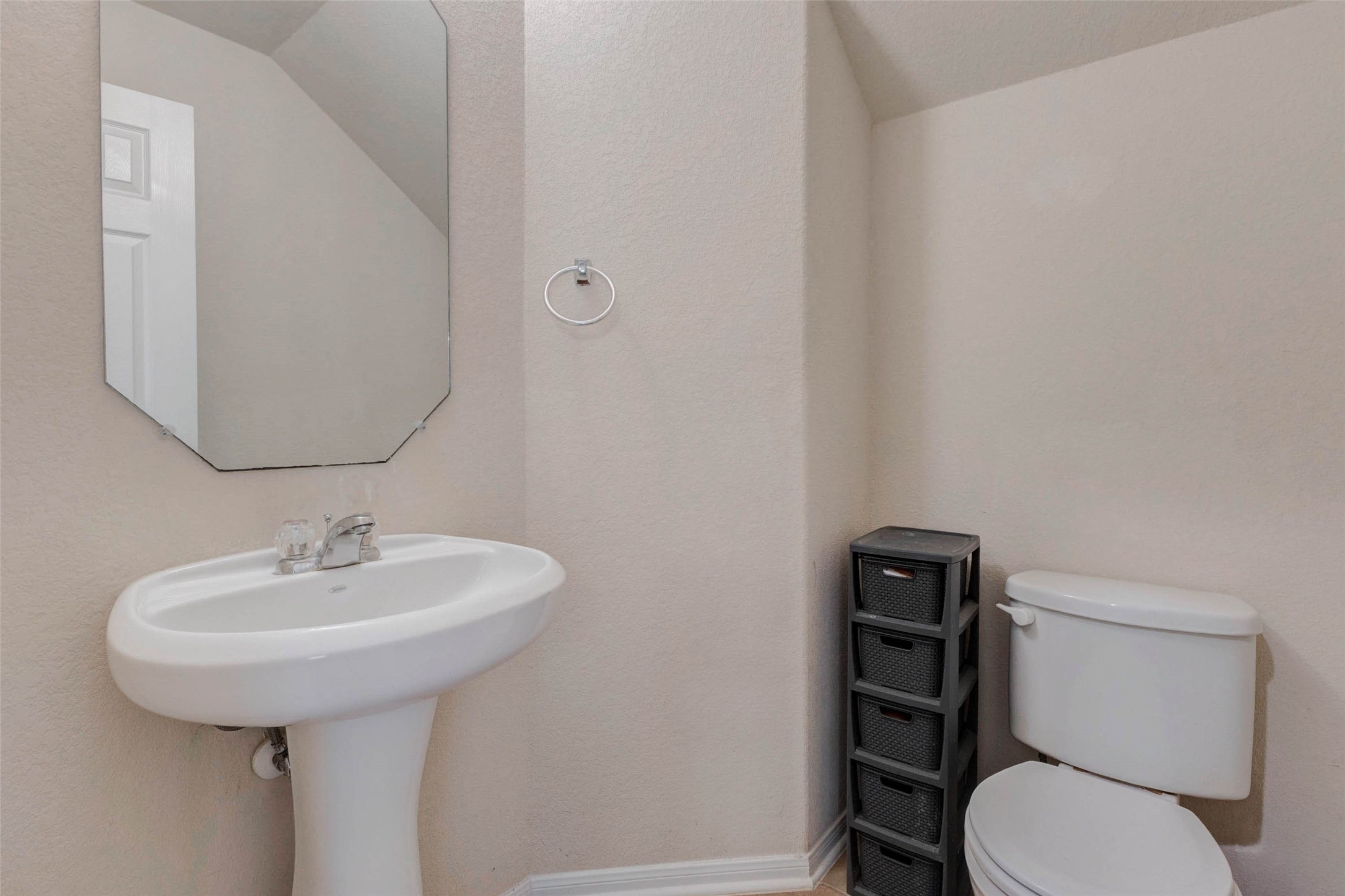 3027 Upland Spring Trace Katy, TX 77493 - Photo 6 of 29 a bathroom with a toilet sink and mirror