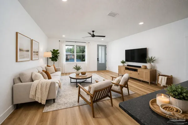 a living room with furniture and a flat screen tv
