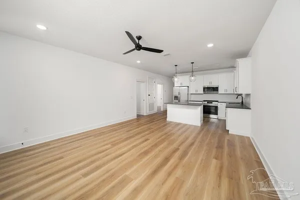 a view of a kitchen with wooden floor