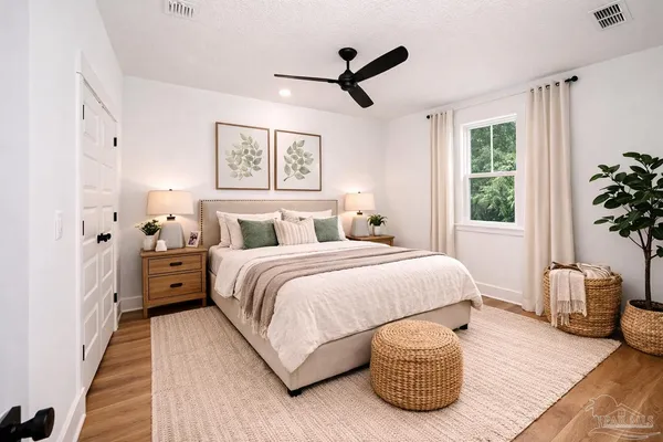 a bedroom with a bed and wooden floor
