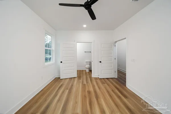 a view of a room with wooden floor and white walls