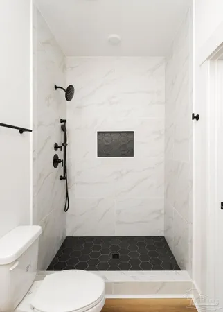 a bathroom with a shower and a toilet