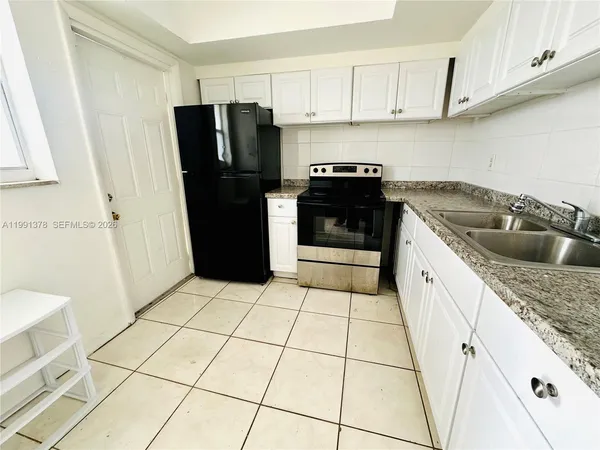 a kitchen with a sink a stove and refrigerator