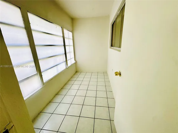 a view of an empty room and window