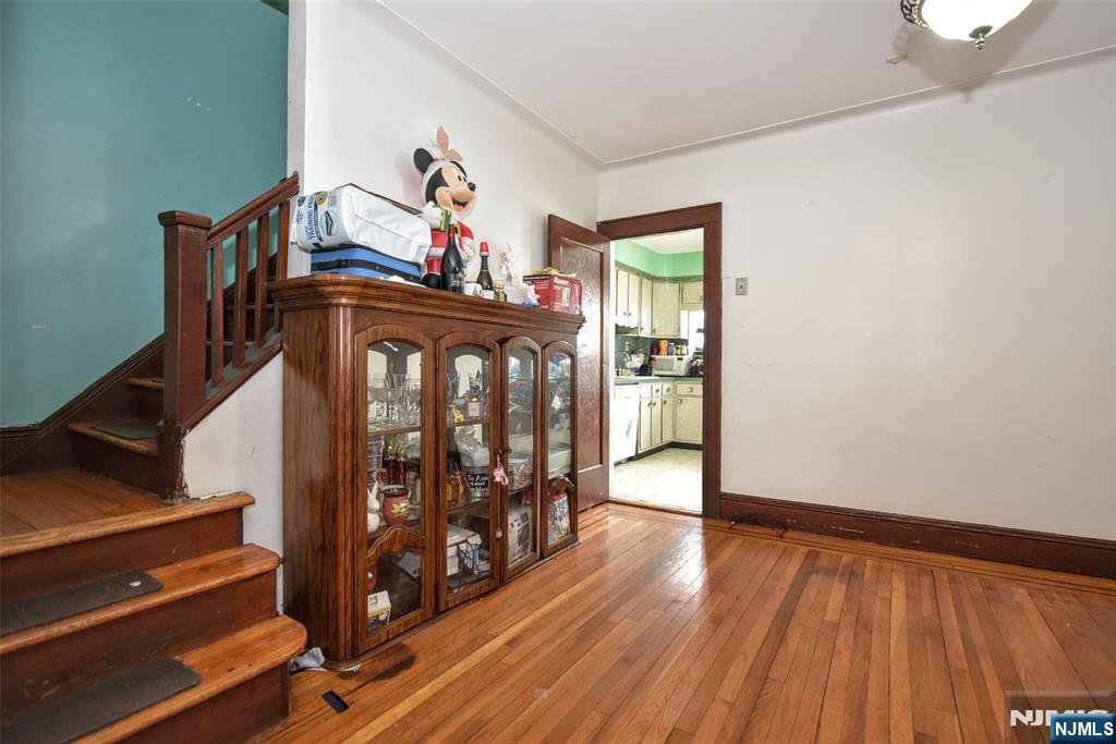 423 North 8th Street Fairview, NJ 07022 - Photo 18 of 30 a view of a hallway with wooden floor and stairs