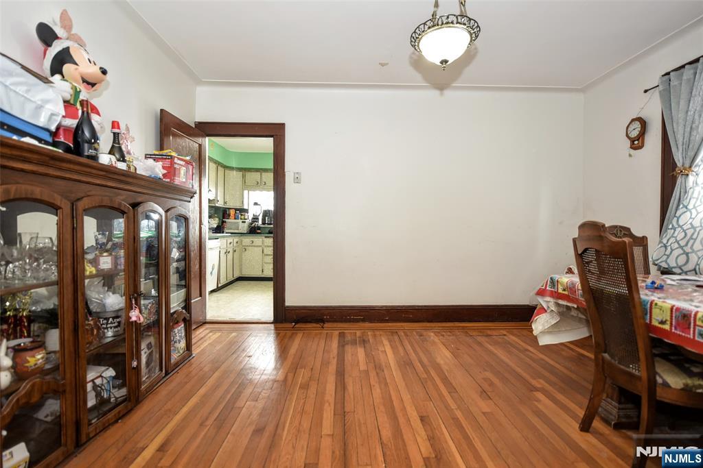 423 North 8th Street Fairview, NJ 07022 - Photo 19 of 30 a view of a hallway with wooden floor and workspace
