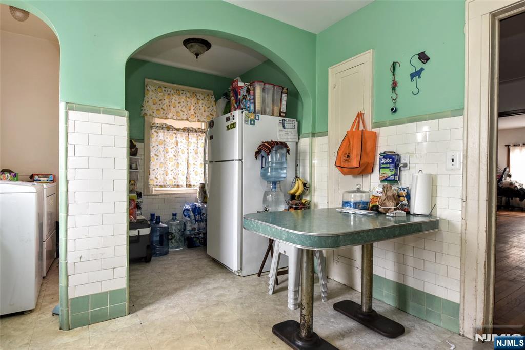 423 North 8th Street Fairview, NJ 07022 - Photo 22 of 30 a view of a dining room with furniture and a chandelier