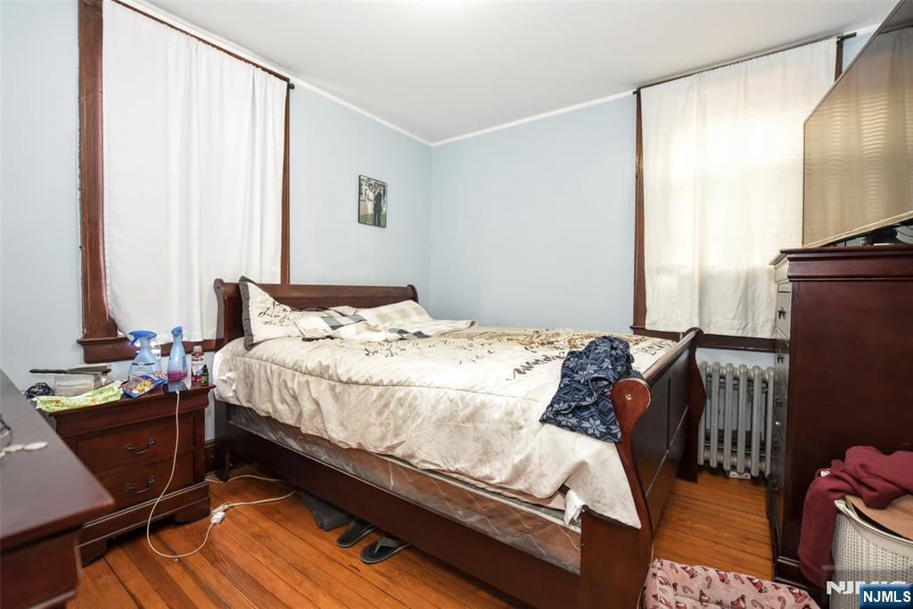 423 North 8th Street Fairview, NJ 07022 - Photo 25 of 30 a bedroom with a bed window and a table in it