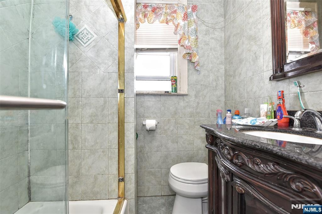 423 North 8th Street Fairview, NJ 07022 - Photo 26 of 30 a bathroom with a sink a toilet and shower