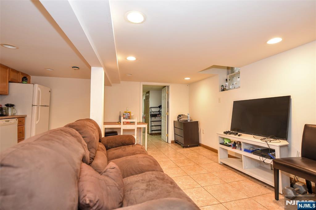 423 North 8th Street Fairview, NJ 07022 - Photo 8 of 30 a living room with furniture and a flat screen tv