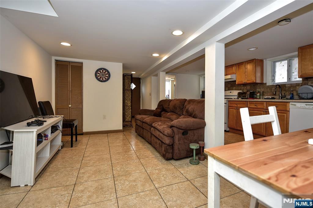 423 North 8th Street Fairview, NJ 07022 - Photo 9 of 30 a living room with stainless steel appliances furniture a rug and a kitchen view