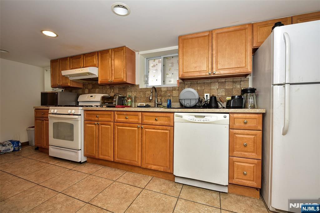 423 North 8th Street Fairview, NJ 07022 - Photo 10 of 30 a kitchen with a stove sink and cabinets