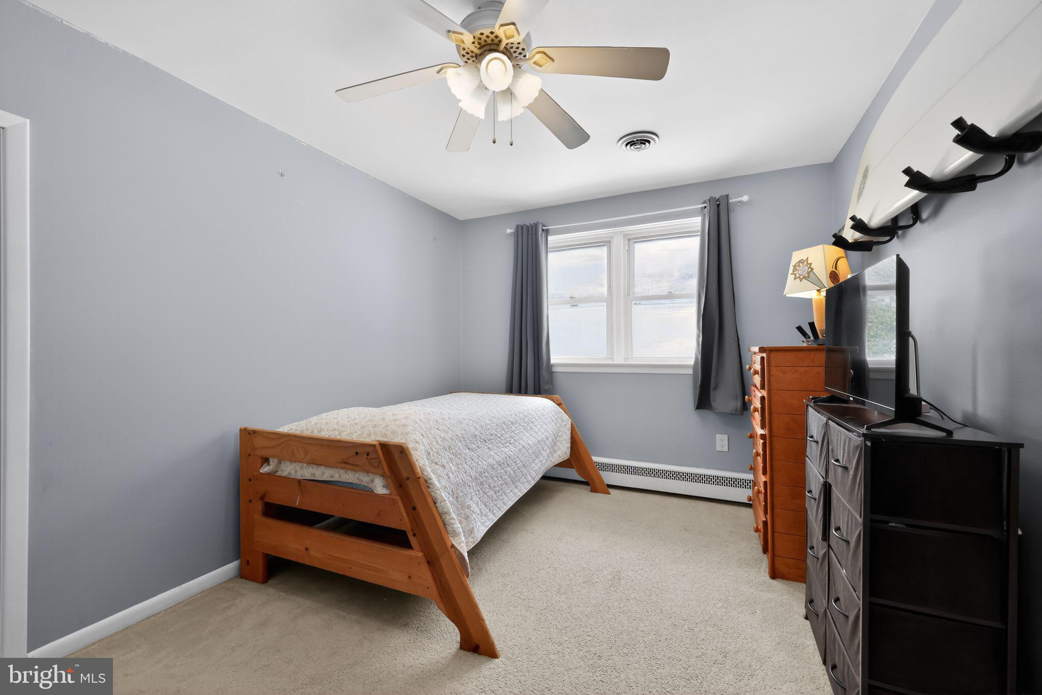3206 Manor Road Huntingdon Valley, PA 19006 - Photo 21 of 37 a bedroom with a bed and a flat tv screen on the dresser