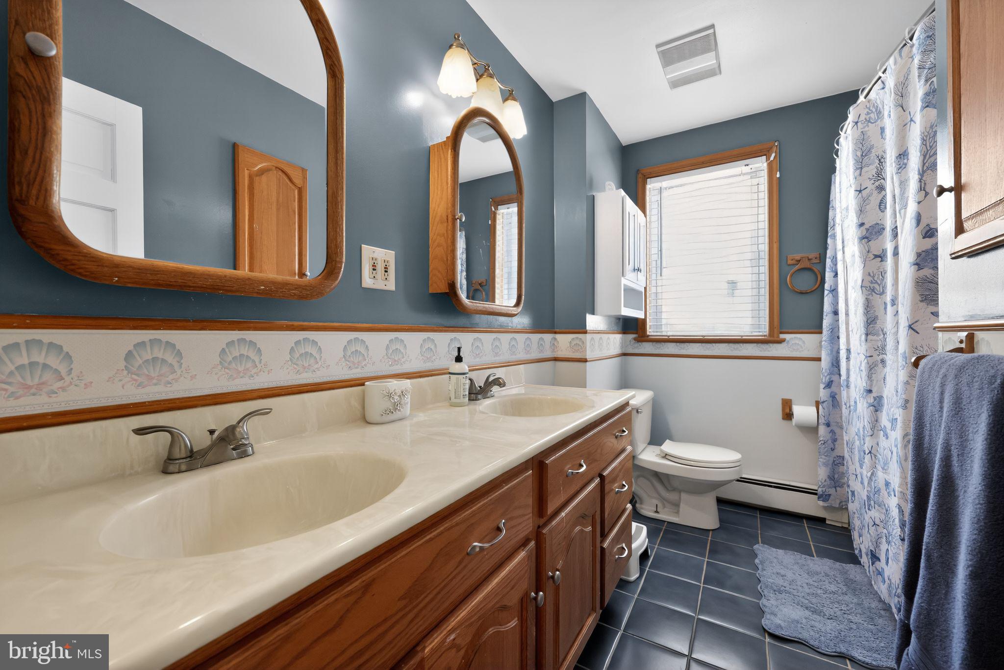 3206 Manor Road Huntingdon Valley, PA 19006 - Photo 23 of 37 a bathroom with a double vanity sink mirror and toilet