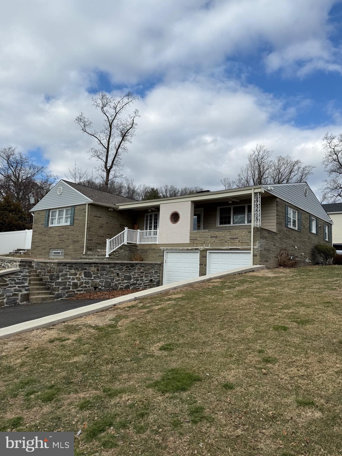 3206 Manor Road Huntingdon Valley, PA 19006 - Photo 5 of 37 a front view of a house with a garden