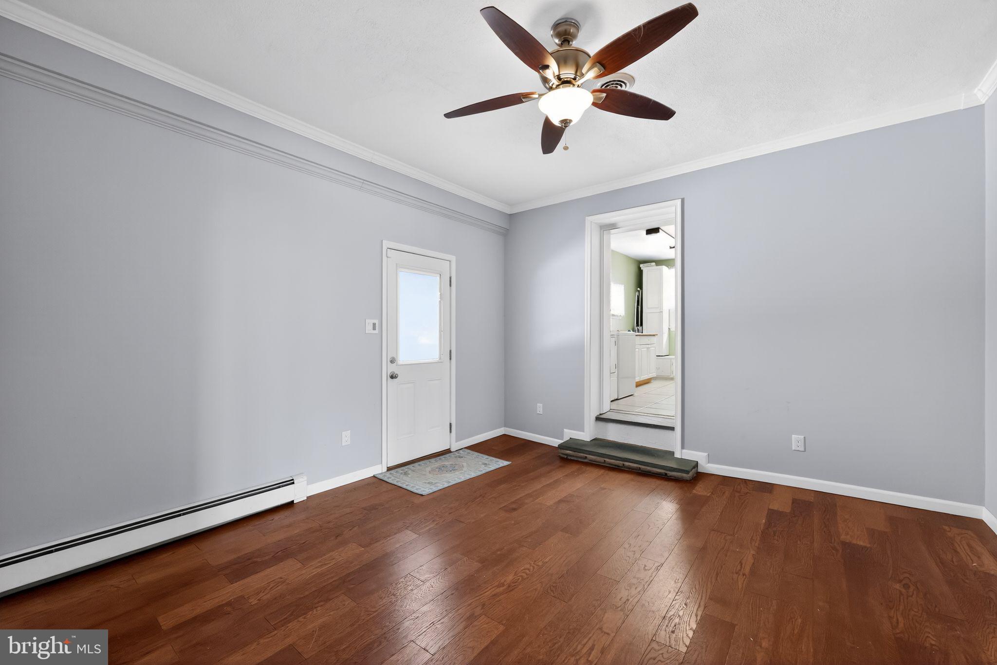 3206 Manor Road Huntingdon Valley, PA 19006 - Photo 9 of 37 an empty room with wooden floor and windows