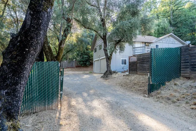 a view of a house with a tree and a yard
