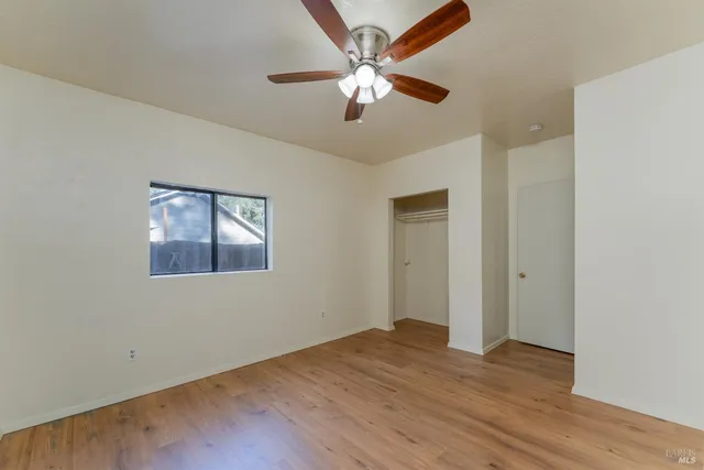 a view of an empty room with wooden floor