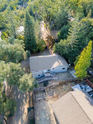 an aerial view of a house with a yard basket ball court and outdoor seating