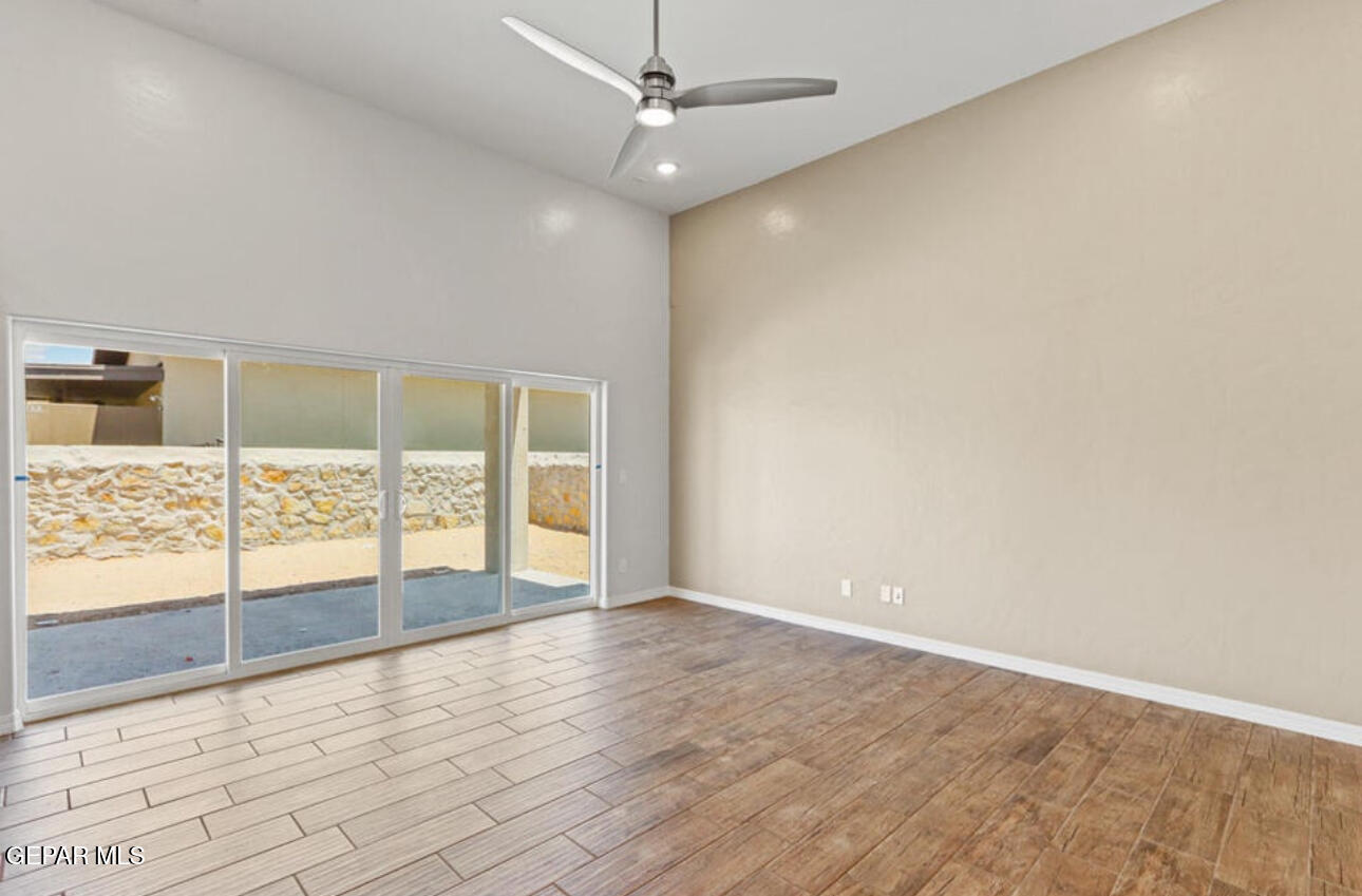 6044 Fall Ridge Sunland Park, NM 88008 - Photo 2 of 13 an empty room with wooden floor and windows