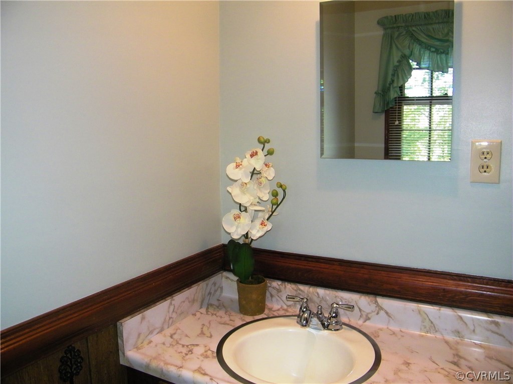 13401 Inge Road Chester, VA 23836 - Photo 15 of 24 a bathroom with a sink and a mirror