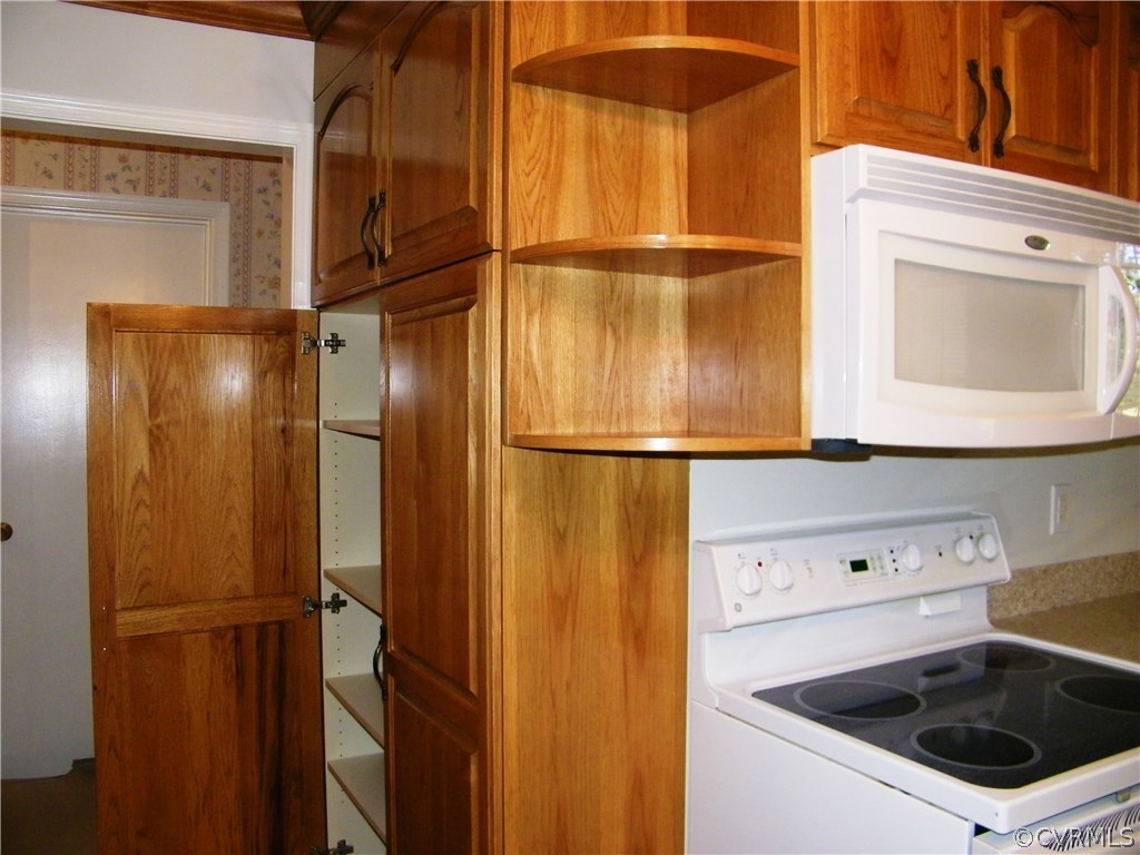 13401 Inge Road Chester, VA 23836 - Photo 7 of 24 a kitchen with a refrigerator and cabinets