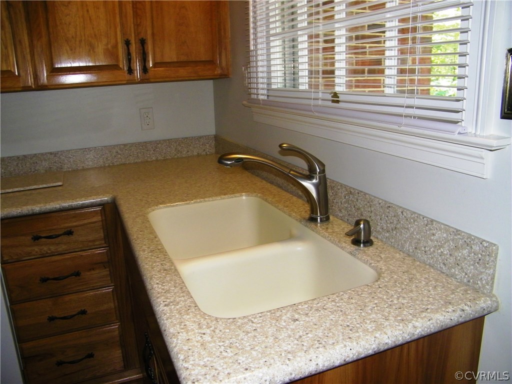 13401 Inge Road Chester, VA 23836 - Photo 8 of 24 a bathroom with a granite countertop sink and a window