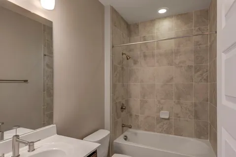 a bathroom with a bathtub a toilet and a shower