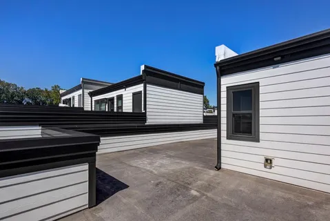 a view of a house with a wooden fence