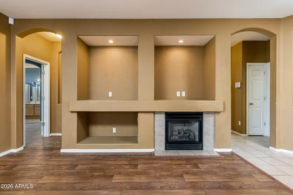 a view of an empty room with fire place and a fireplace