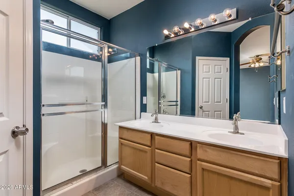 a bathroom with a double vanity sink and mirror