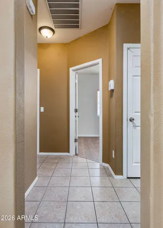 a view of a hallway with wooden shelves