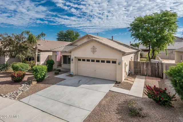 front view of a house with a bench