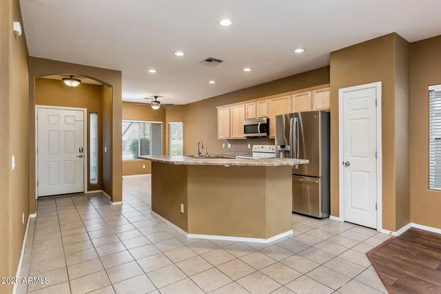 a kitchen with stainless steel appliances a refrigerator and a stove top oven